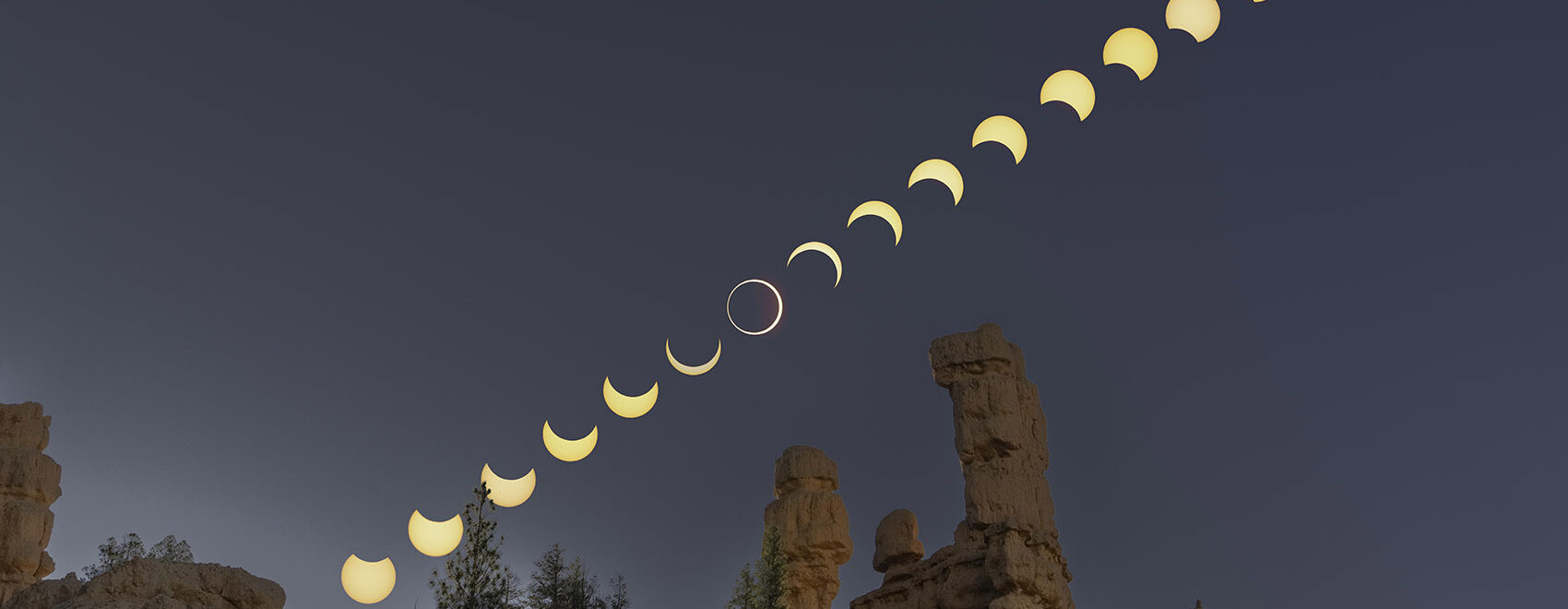 annular eclipse above rock hoodoos