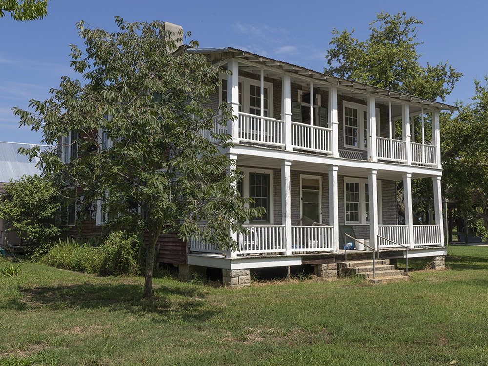 2 story wood building with porches