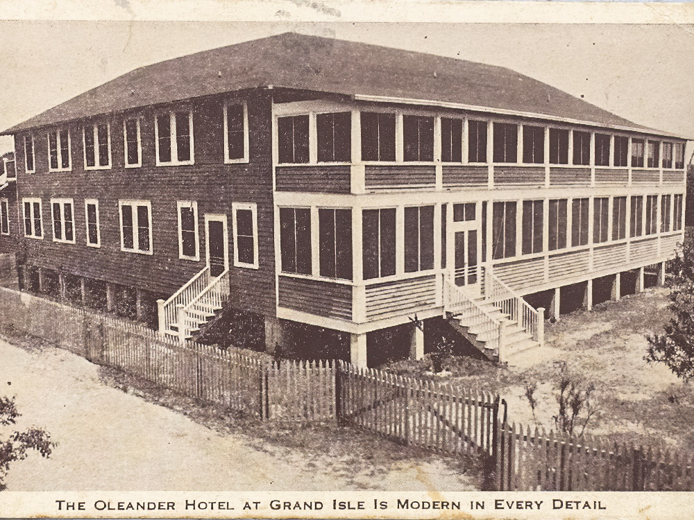 old black and white postcard of 2 story wood hotel with porches