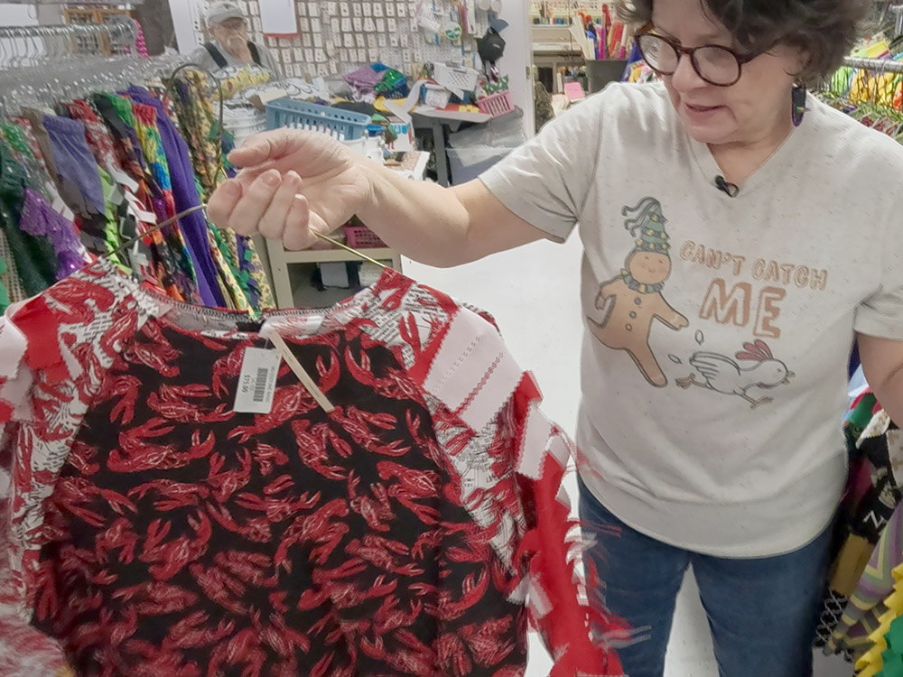 woman holds costume with crawfish design