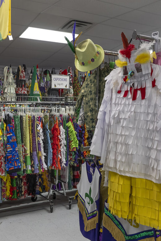 Cajun Mardi Gras costumes hanging on store clothing racks