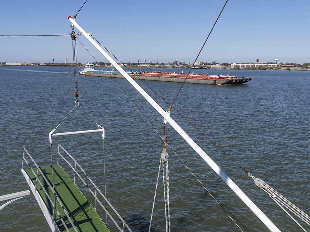 boarge and tow passing steamboat during Mississippi River cruise