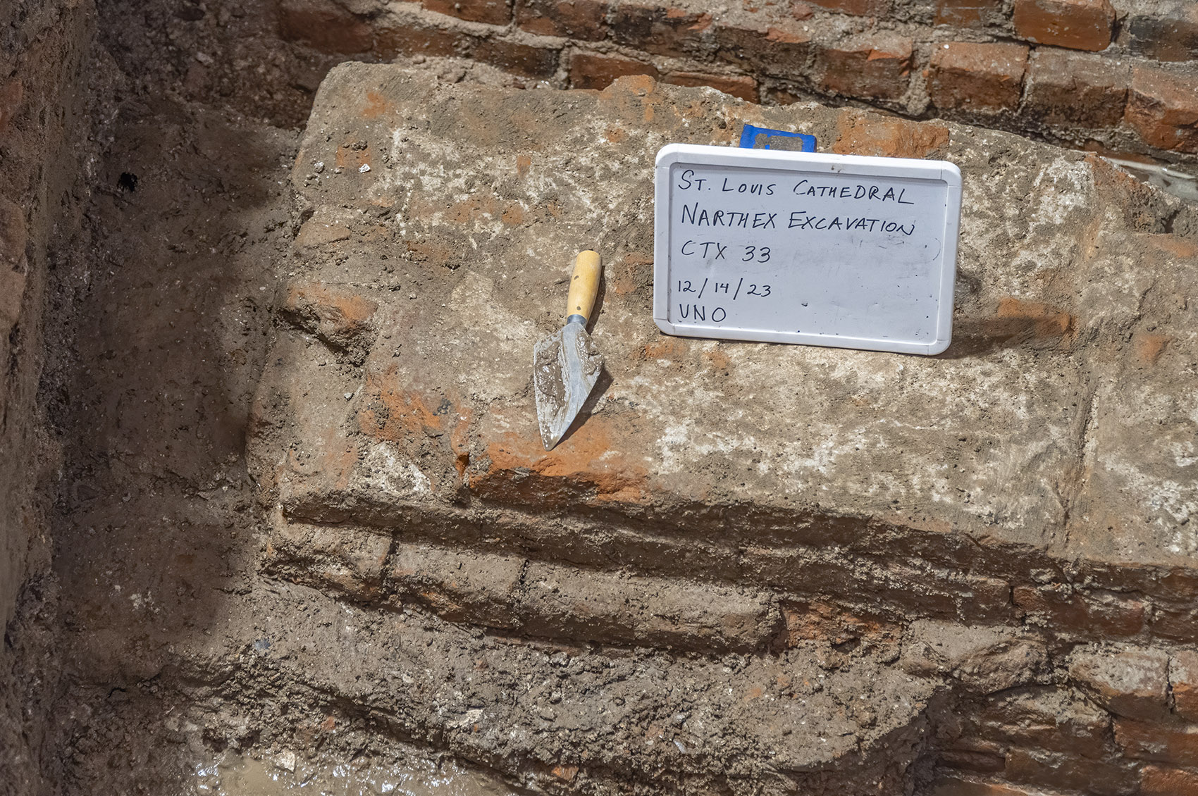 archaeology excavation trowel sign bricks cathedral
