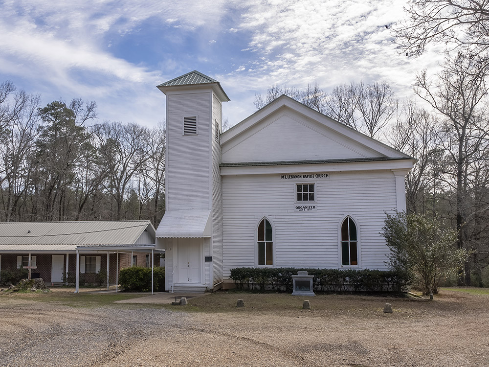 white wooden Mount Lebanon Baptist church with blue sky and white clouds