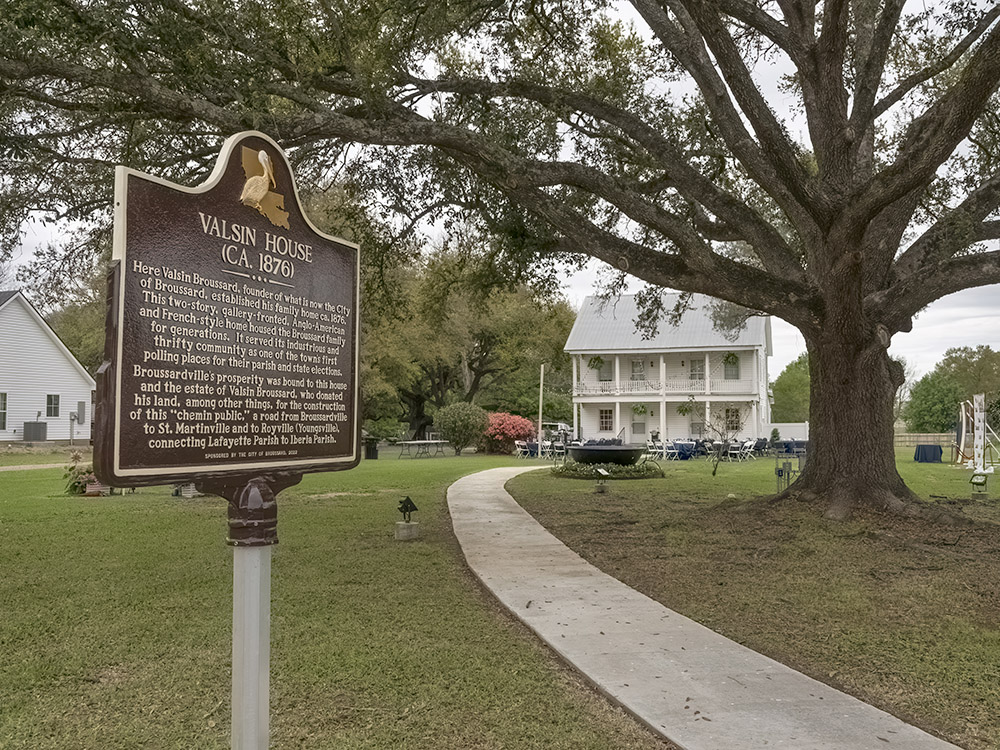 historic marker in front of white 2.5 story home of Valsin Broussard
