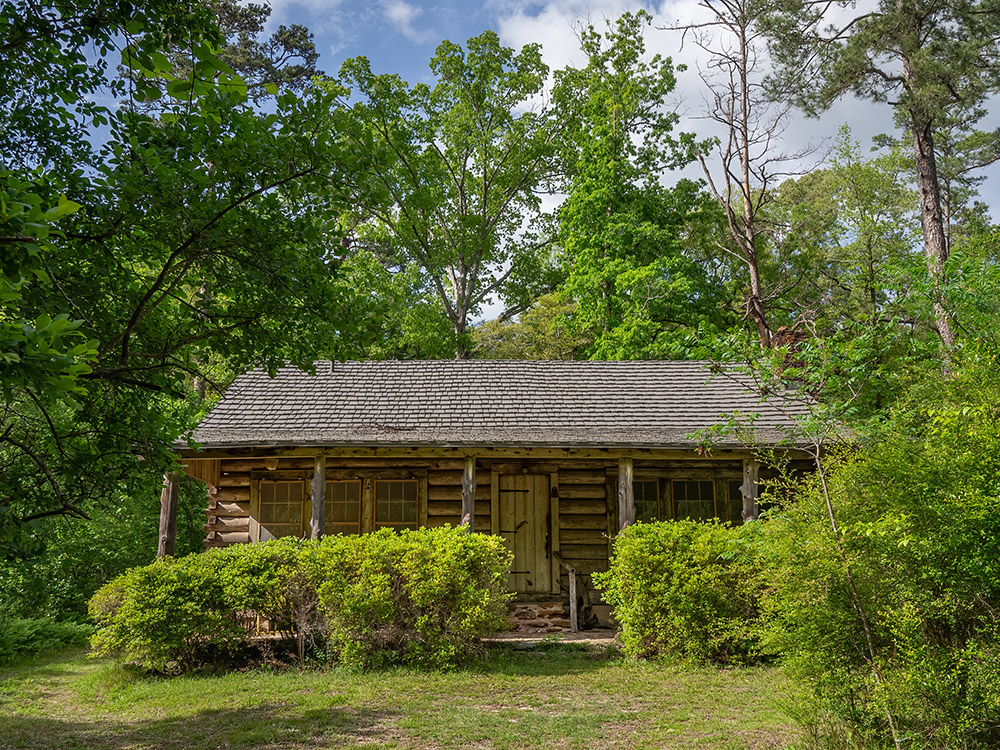 log cabin home of Caroline Dormon in wooded area