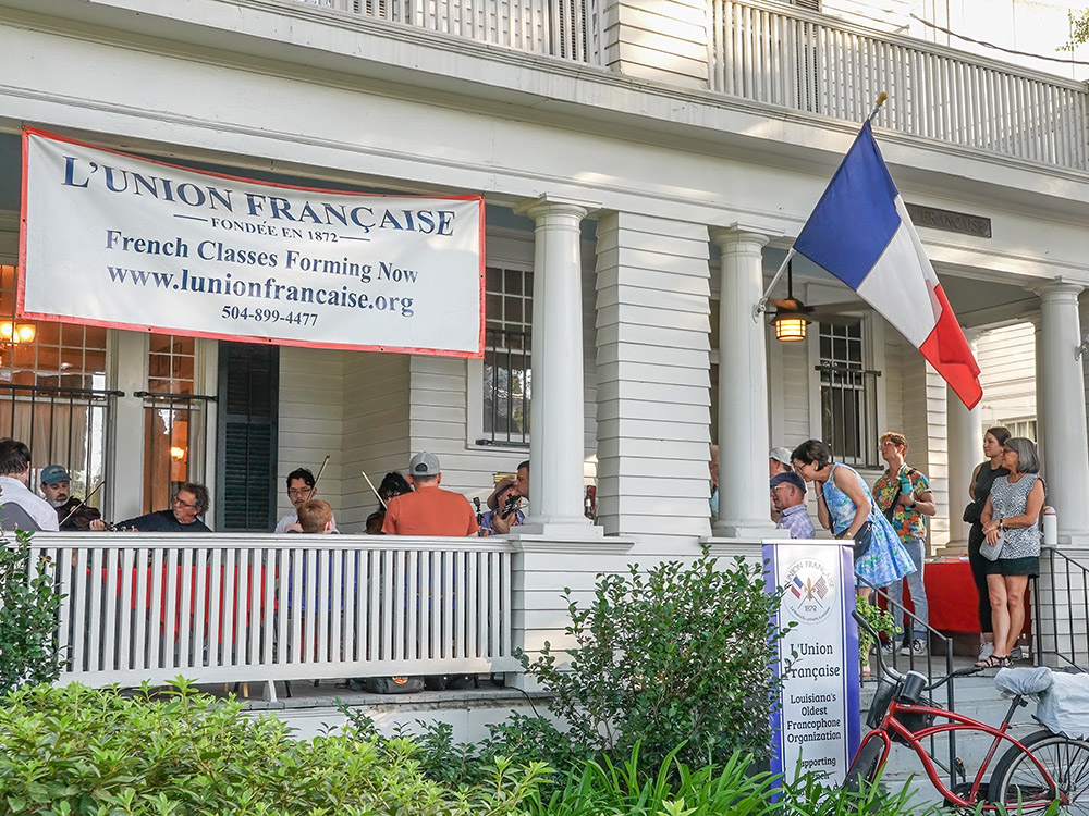 sign for L'Union Francaise on porch of white house with Cajun music in New Orleans