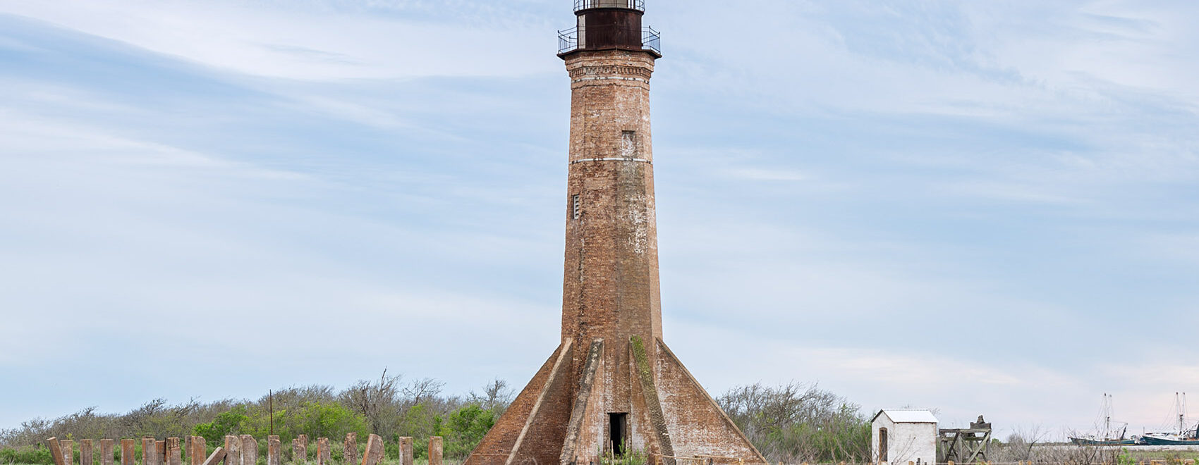 red brick lighthouse with black iron top