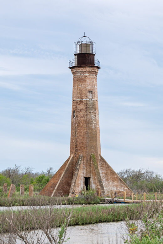 red brick lighthouse with black iron top