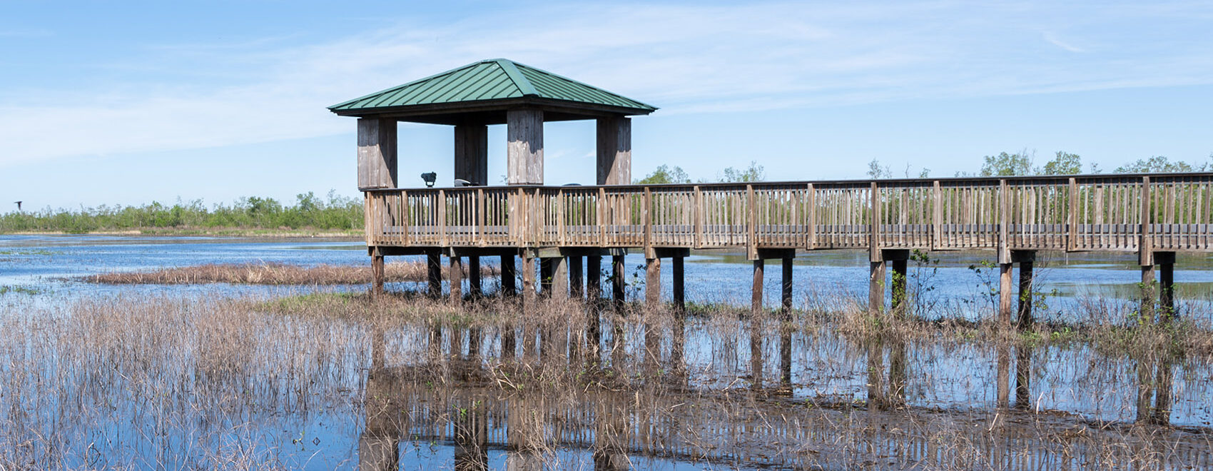 wood observation deck and boardwalk over marsh on Creole Nature Trail