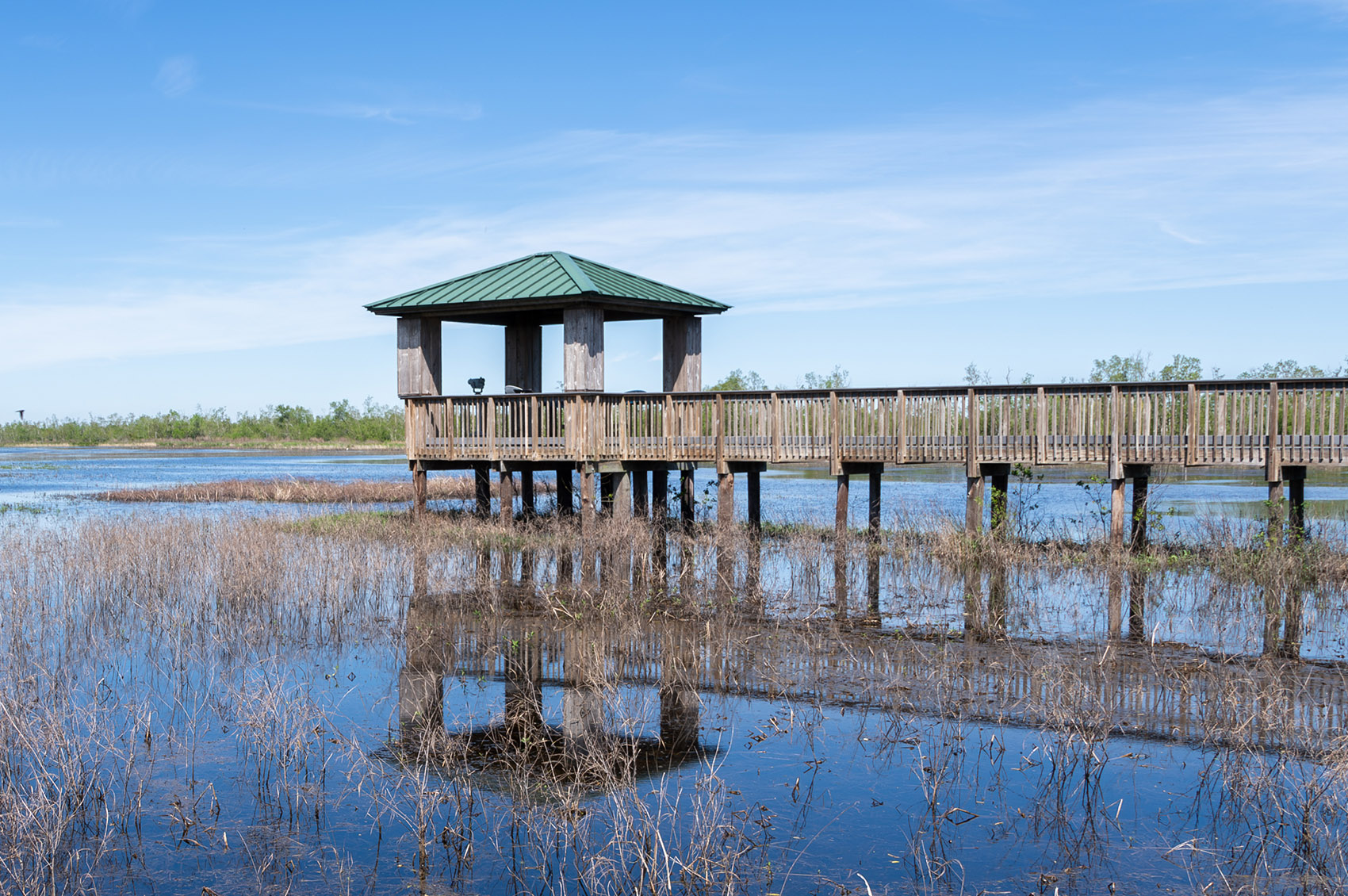 wood observation deck and boardwalk over marsh on Creole Nature Trail