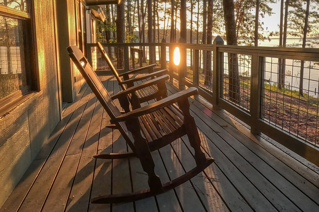 rocking chairs on cabin deck at sunset at Lake Claiborne State Park