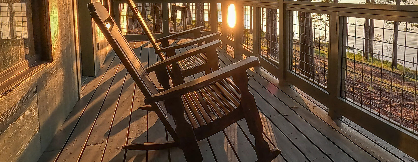 rocking chairs on cabin deck at sunset at Lake Claiborne State Park