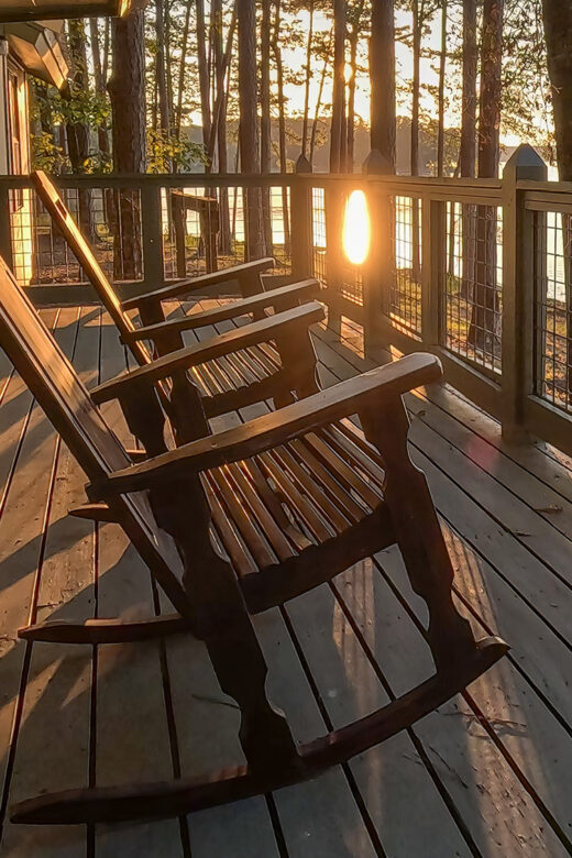 rocking chairs on cabin deck at sunset at Lake Claiborne State Park