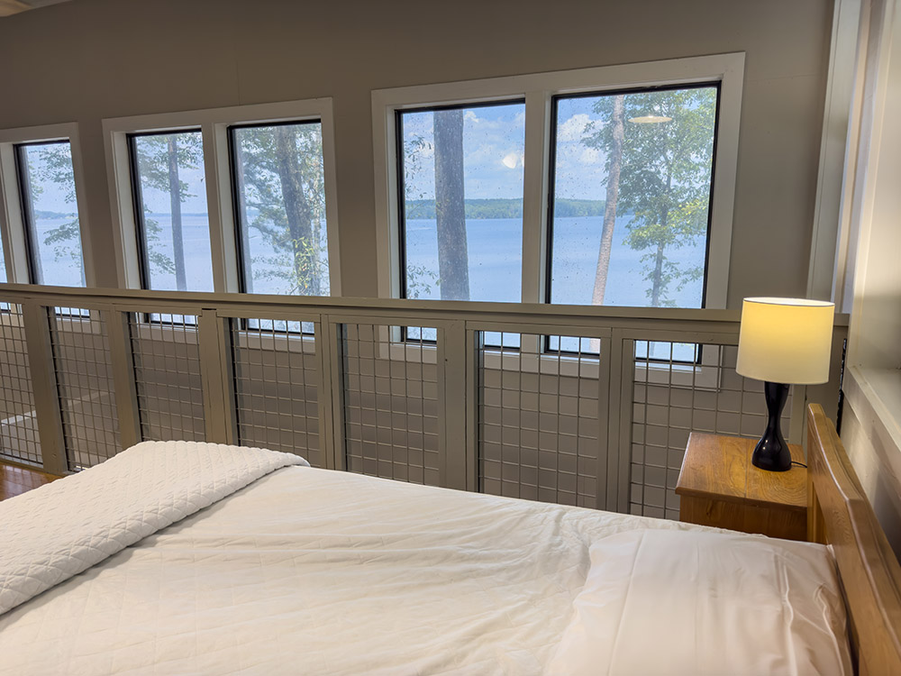 view of lake from loft bedroom in cabin