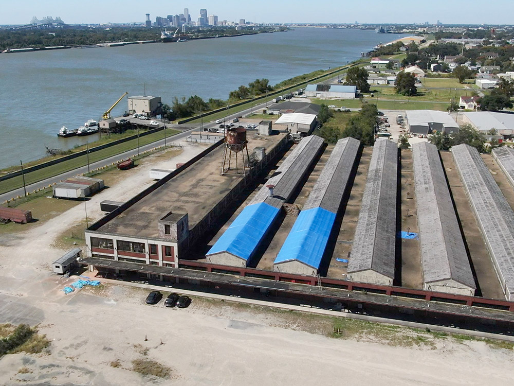 aerial view of old ford assembly plant along Mississippi River with New Orleans skyline in the distance