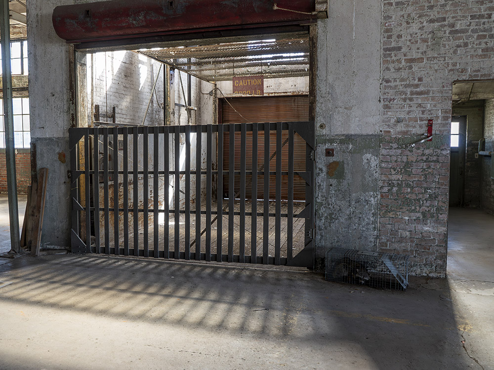 gated freight elevator inside abandoned building