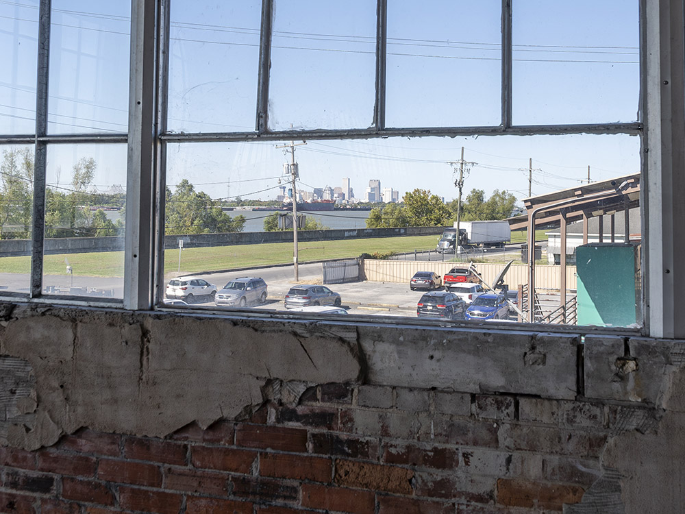 view out of window in old ford assembly plant window of distant city skyline