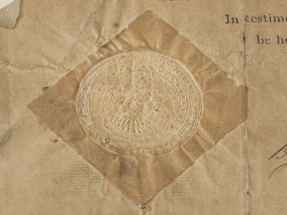 faded paper with embossed seal