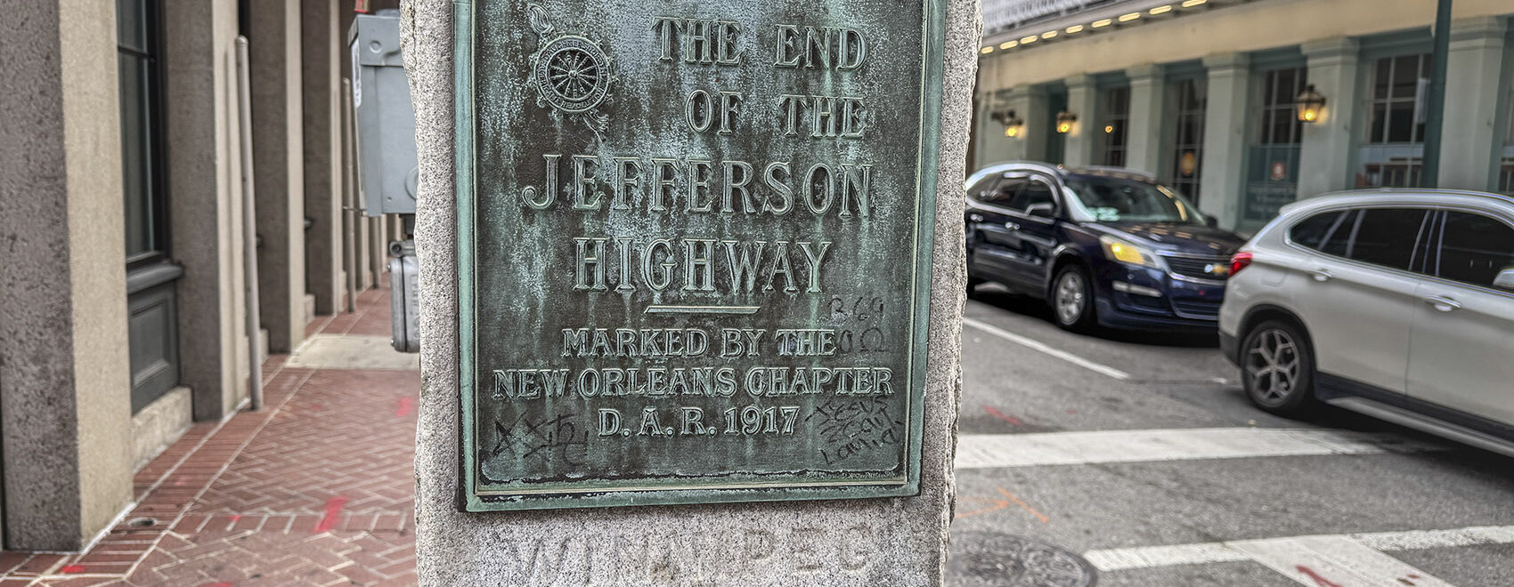 granite monument with metal sign commemorating Jefferson Highway