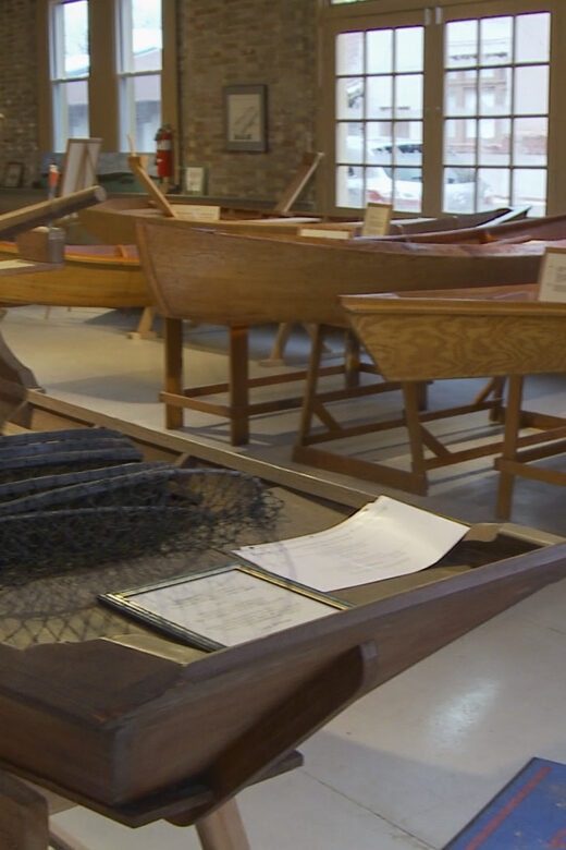 small wooden Cajun style boats in museum