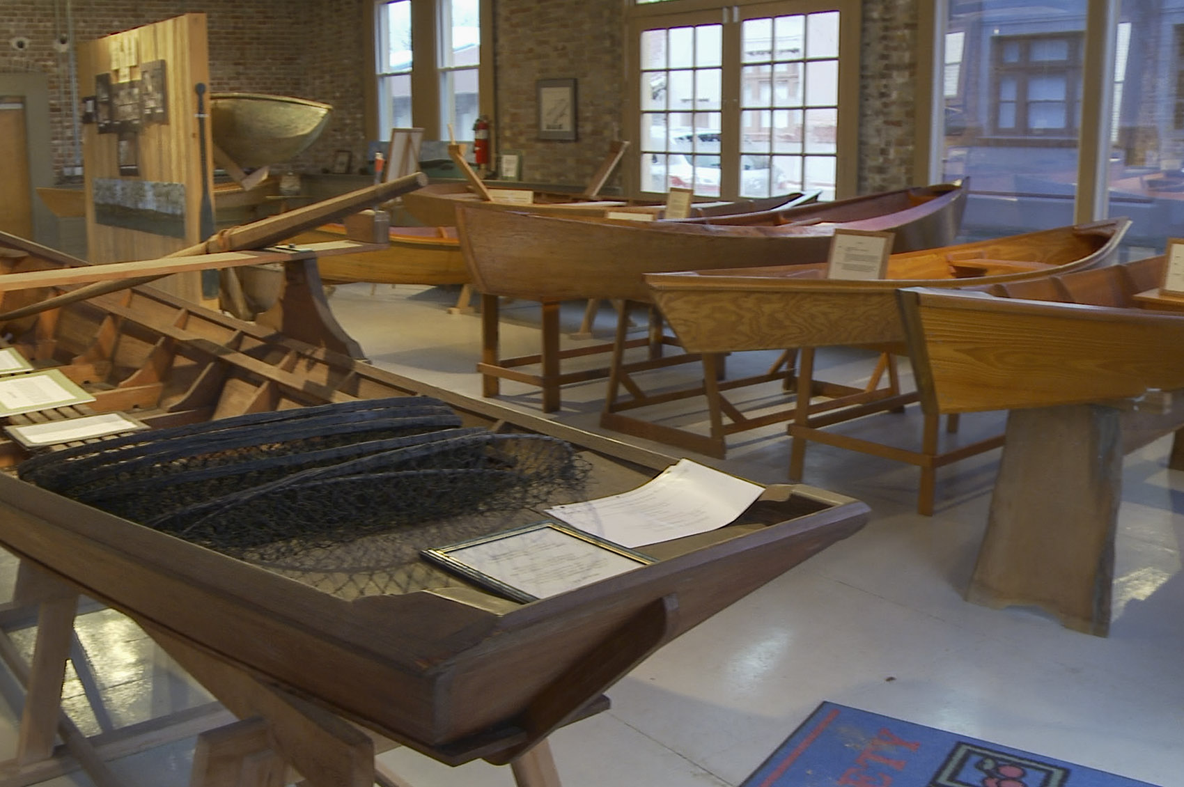 small wooden Cajun style boats in museum