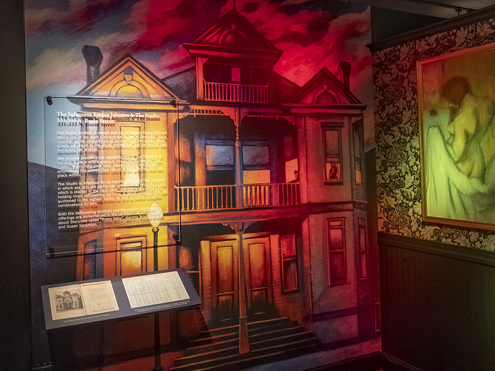 images of victorian houses with colorful lighting and painting of woman in storyville museum