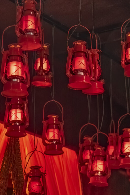 numerous red lanterns handing from ceiling