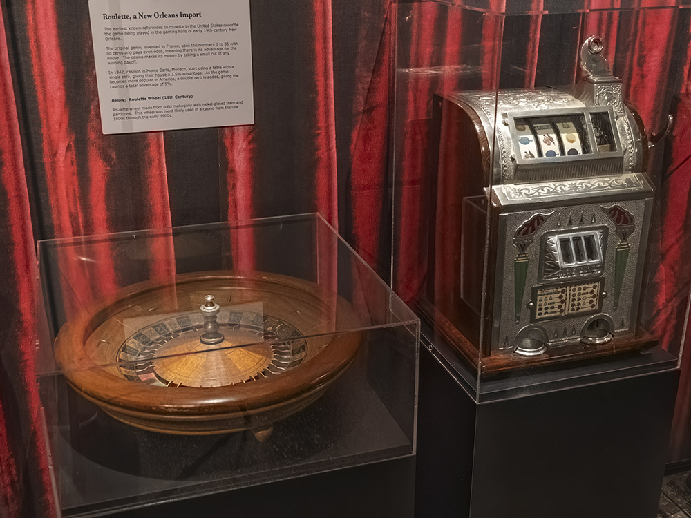 antique roulette wheel and gambling slot machine on display in museum