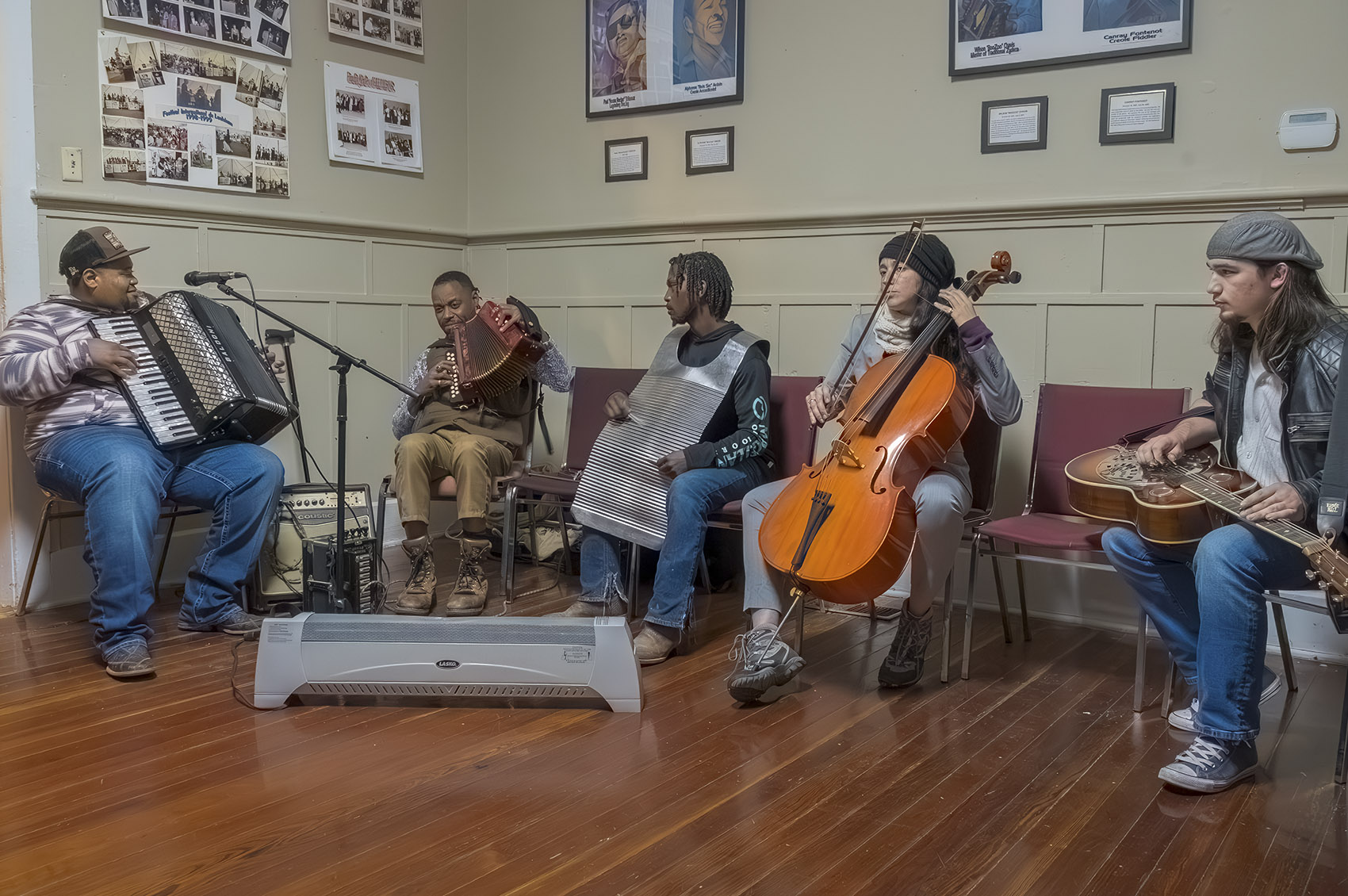 musicians play in jam session on accordion, rub board and cello.