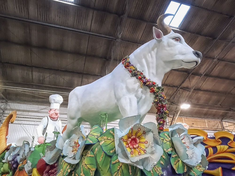 large white cow on colorful Mardi Gras float