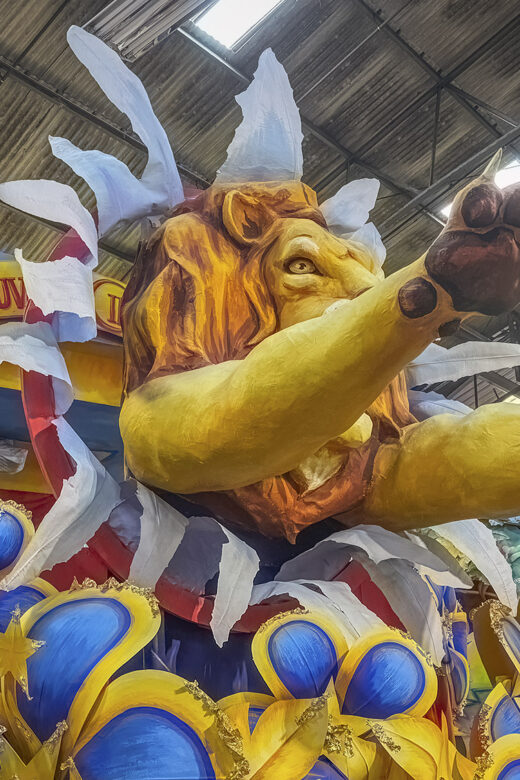 colorful mardi gras float with lion and blue and yellow flowers