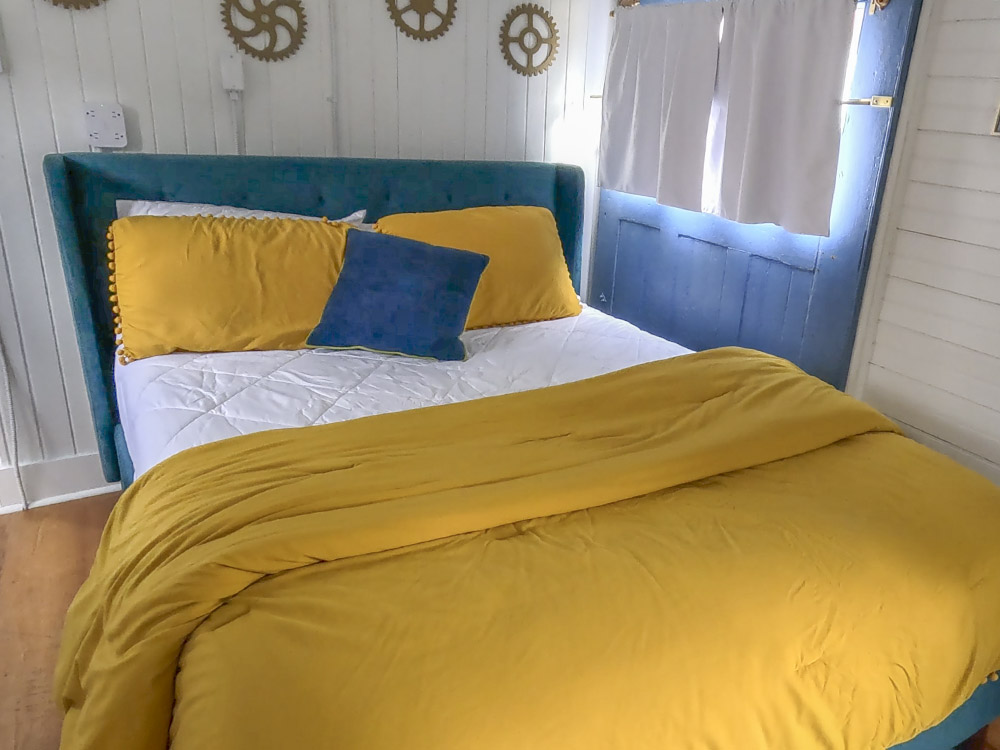 bed with yellow pillows and yellow blanket