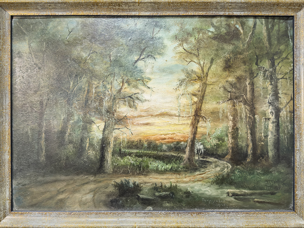 framed painting of winding road through the woods at sunset