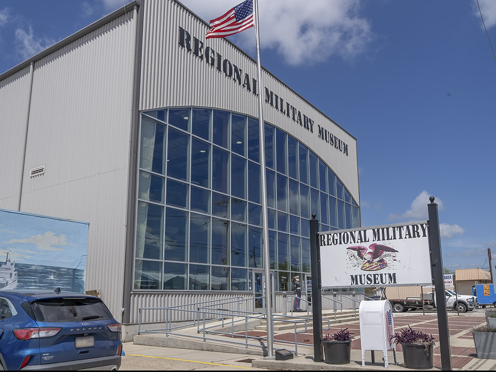 large building with glass front and U S flag at Regional Military Museum