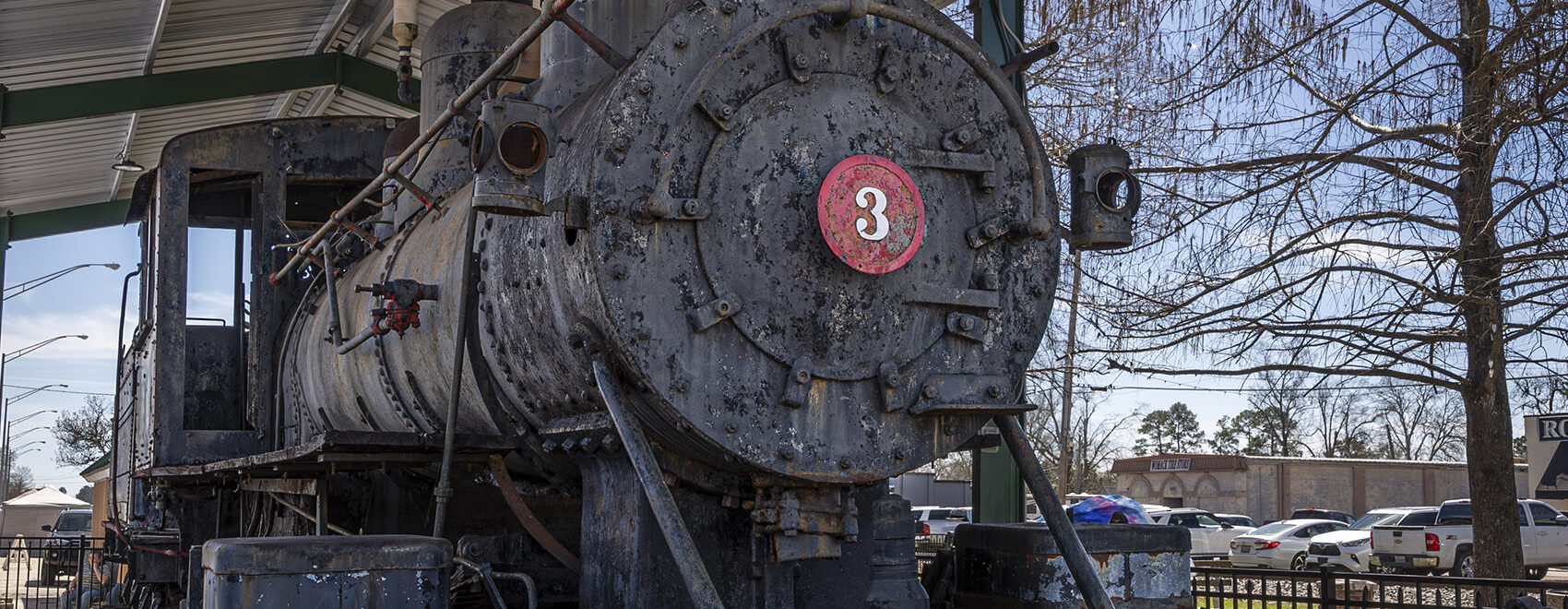 old black colored railroad engine with number 3