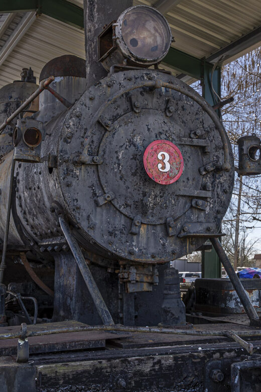 old black colored railroad engine with number 3
