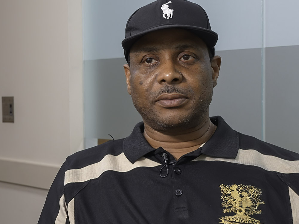 man wearing black cap and black and white striped shirt