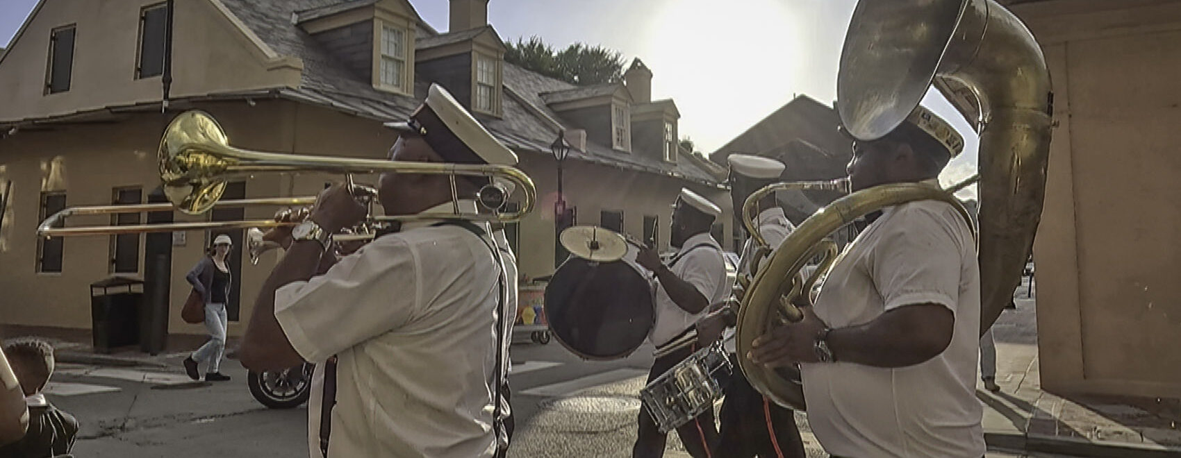 brass band parades through french quarter in New Orleans
