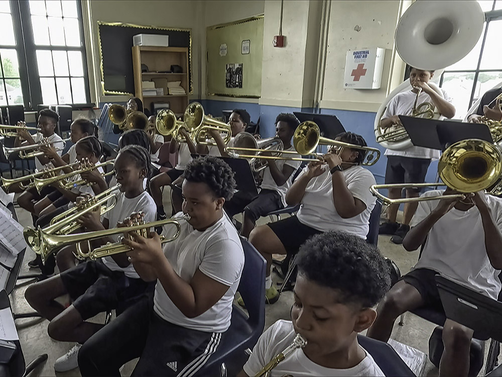 students in music class playing brass instruments