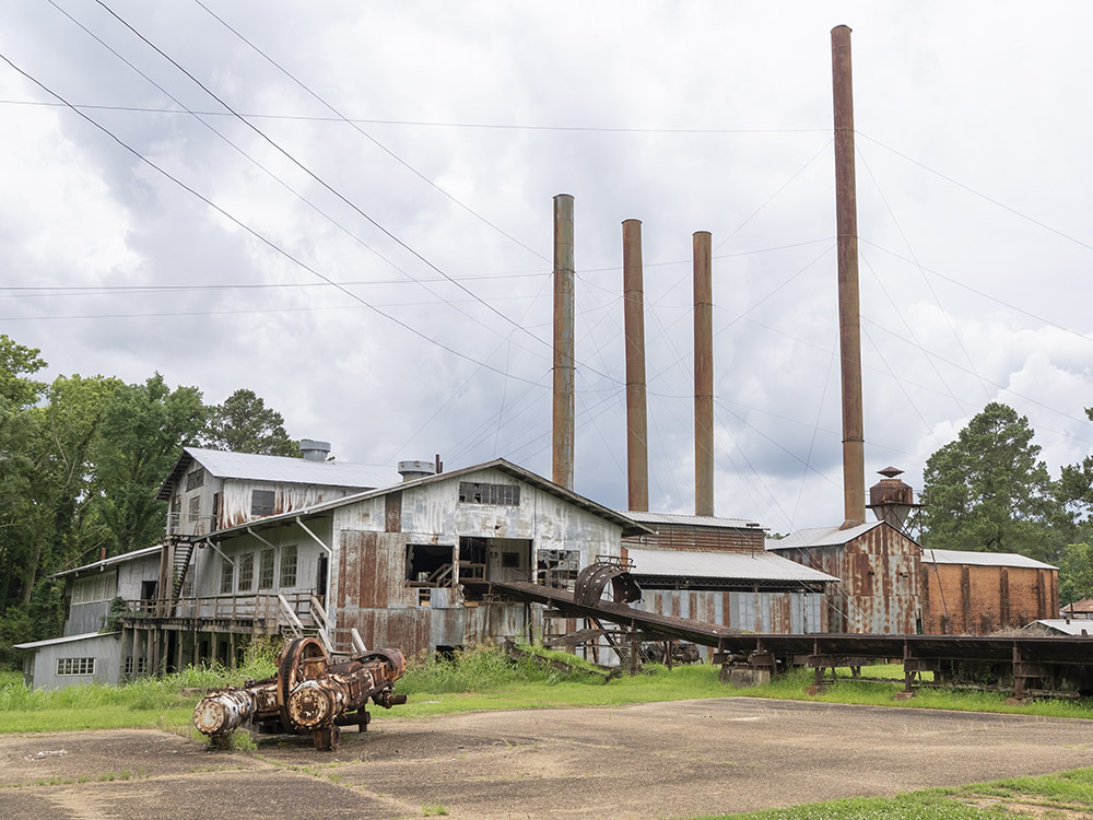old sawmill with four smokestacks