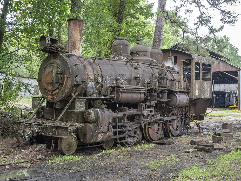 old rusty steam locomotive in woods