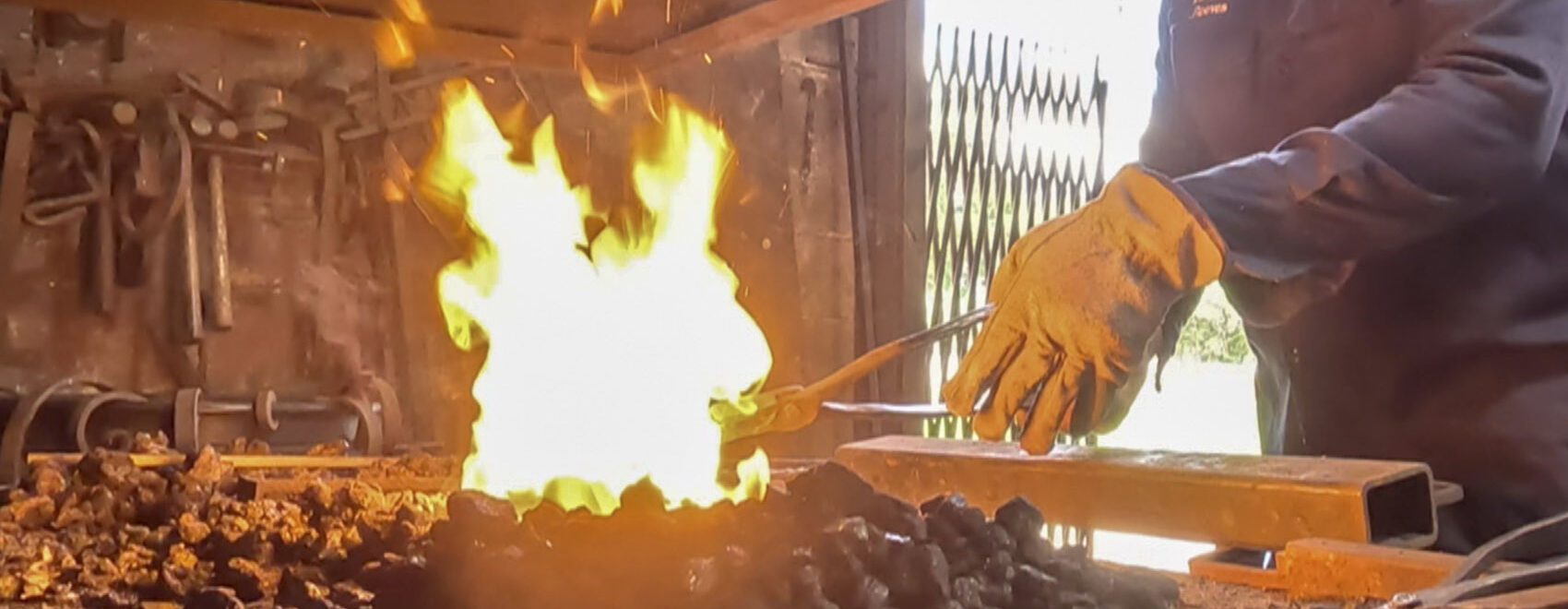 fired pit with blacksmith hand and rod