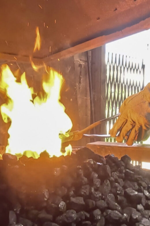 fired pit with blacksmith hand and rod