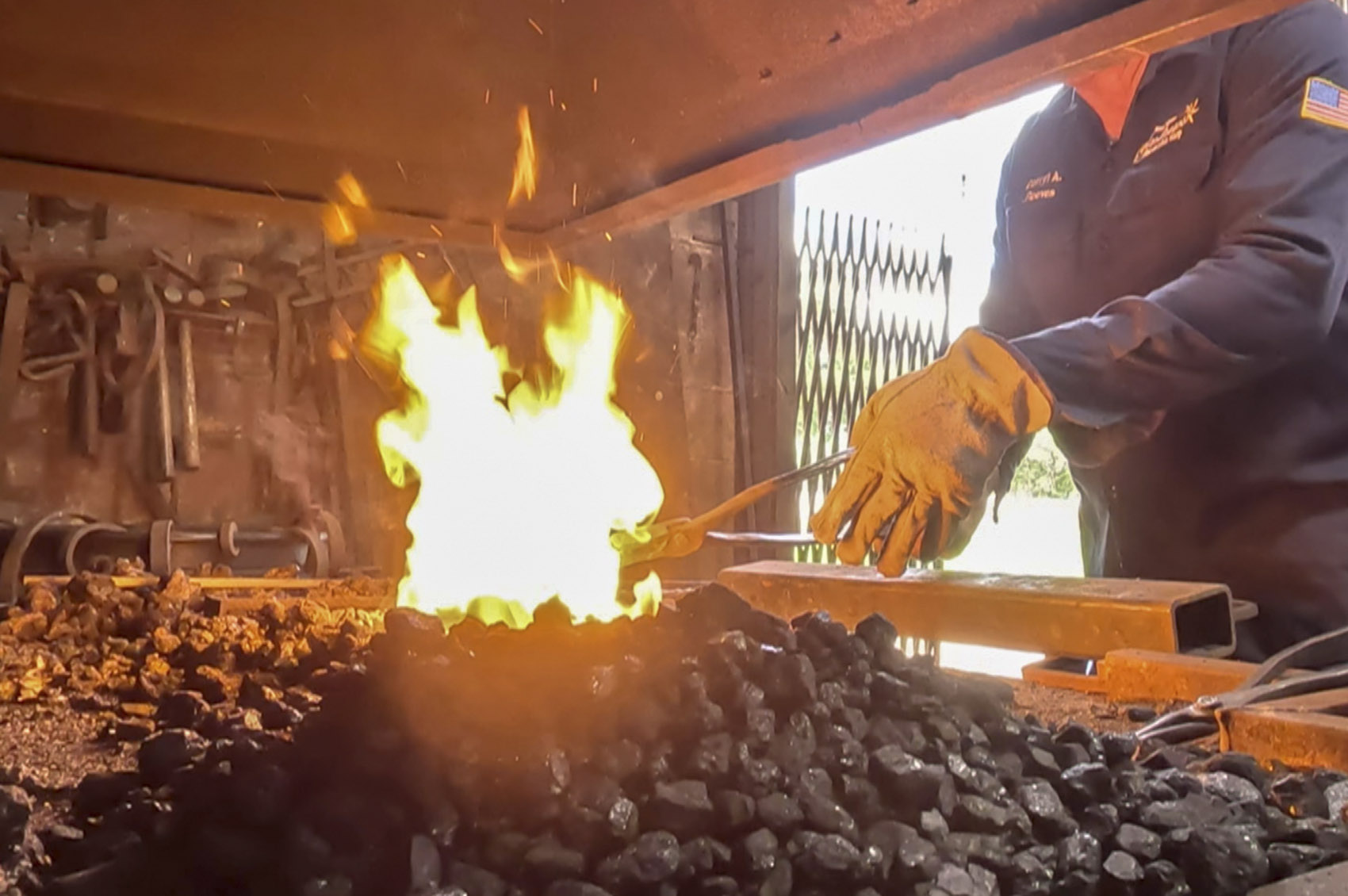 fired pit with blacksmith hand and rod