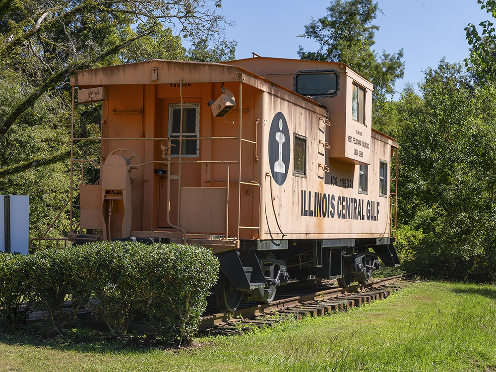 orange caboose of the Illinois Central railroad on public display in park