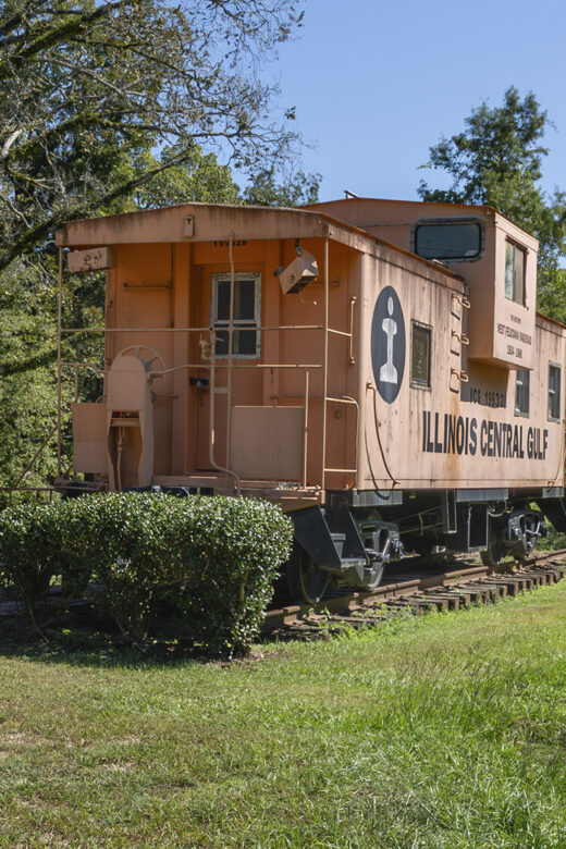orange Illinois Central Caboose on display in park