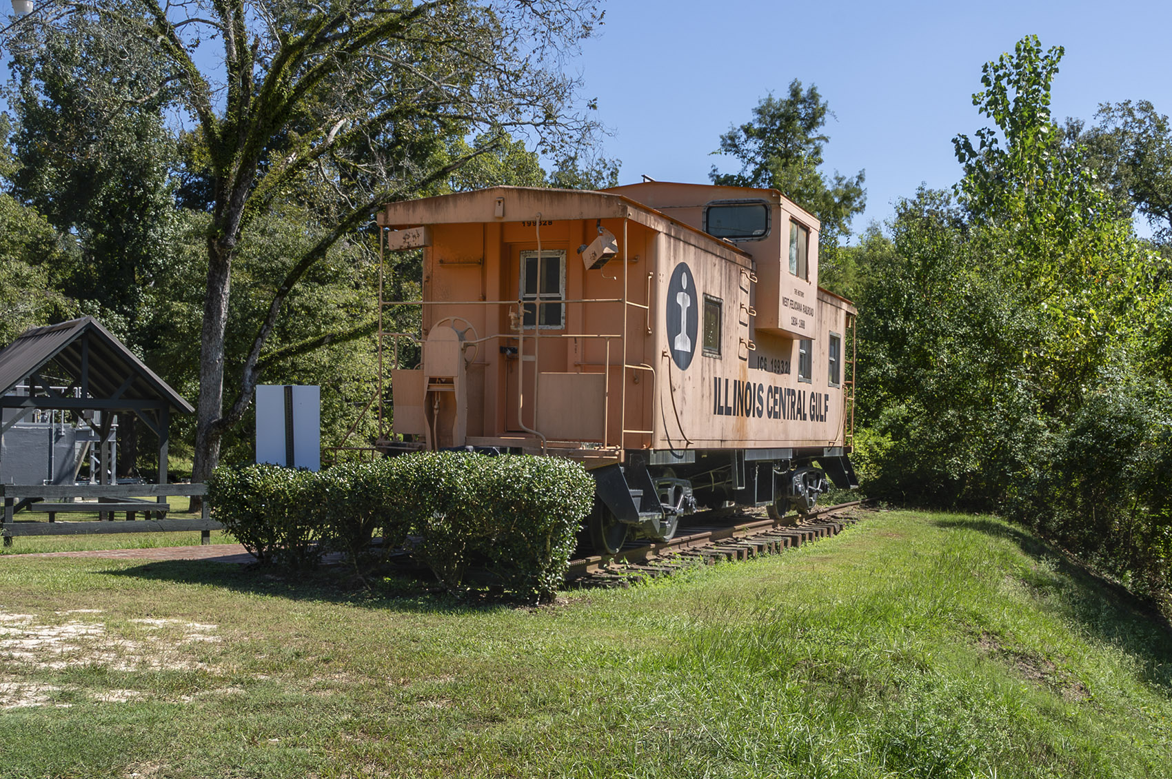 orange Illinois Central Caboose on display in park