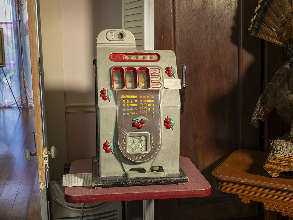 old five cent slot machine on small table in museum