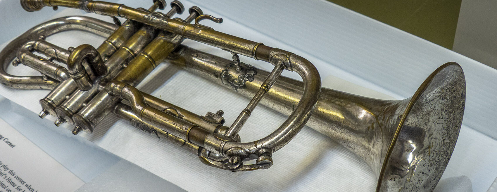 Louis Armstrong's first cornet laying on museum table